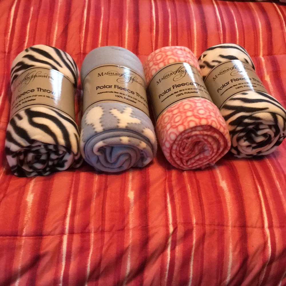 4 Small fleece throws 50 x 60 “ New all 4